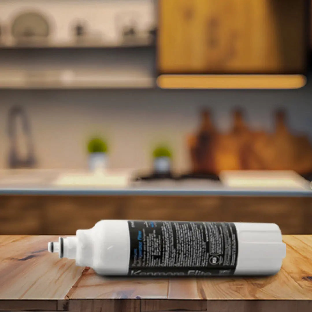 Kenmore Elite 46-9490 Refrigerator Water Filter lying on a wooden kitchen countertop with blurred background cabinets.