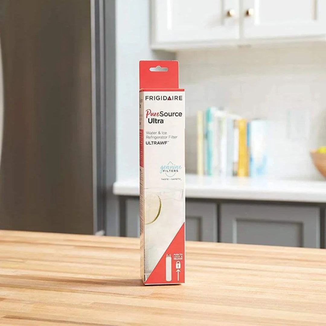 Frigidaire PureSource Ultra ULTRAWF refrigerator water filter retail box placed on a wooden kitchen countertop near refrigerator